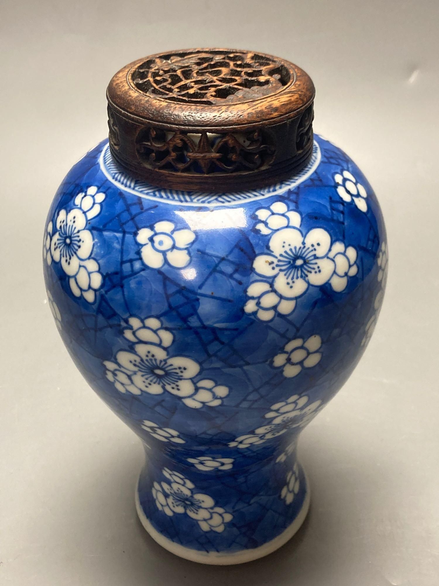 A Chinese blue and white vase, Kangxi period, wood cover, neck reduced, 18cm